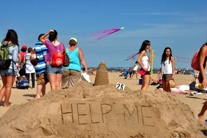 someone wrote "help me" on packed sand at Coney Island